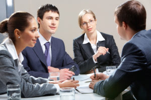 A job candidate interviews in front of a panel of young interviewers, for a job of an assistant principal 